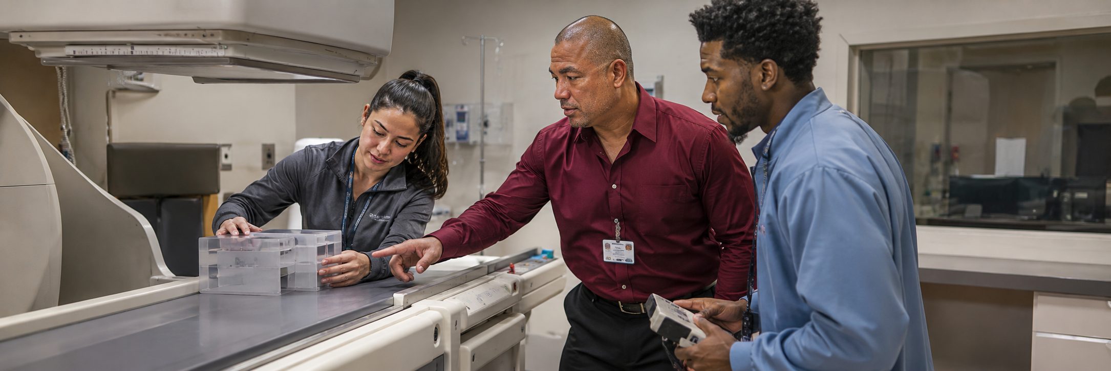 HTM technicians inspecting operating room surgical lights during scheduled service
